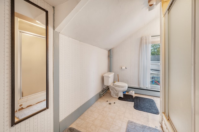 bathroom with lofted ceiling, baseboard heating, and toilet