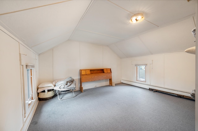 additional living space with baseboard heating, vaulted ceiling, and carpet flooring