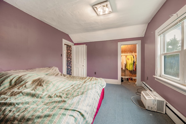 carpeted bedroom featuring lofted ceiling, a closet, and a baseboard radiator