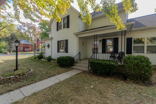 view of front of property featuring a porch and a front yard