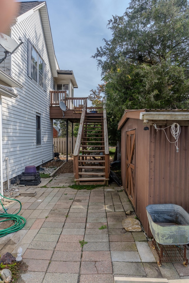 view of patio / terrace featuring a shed and a deck