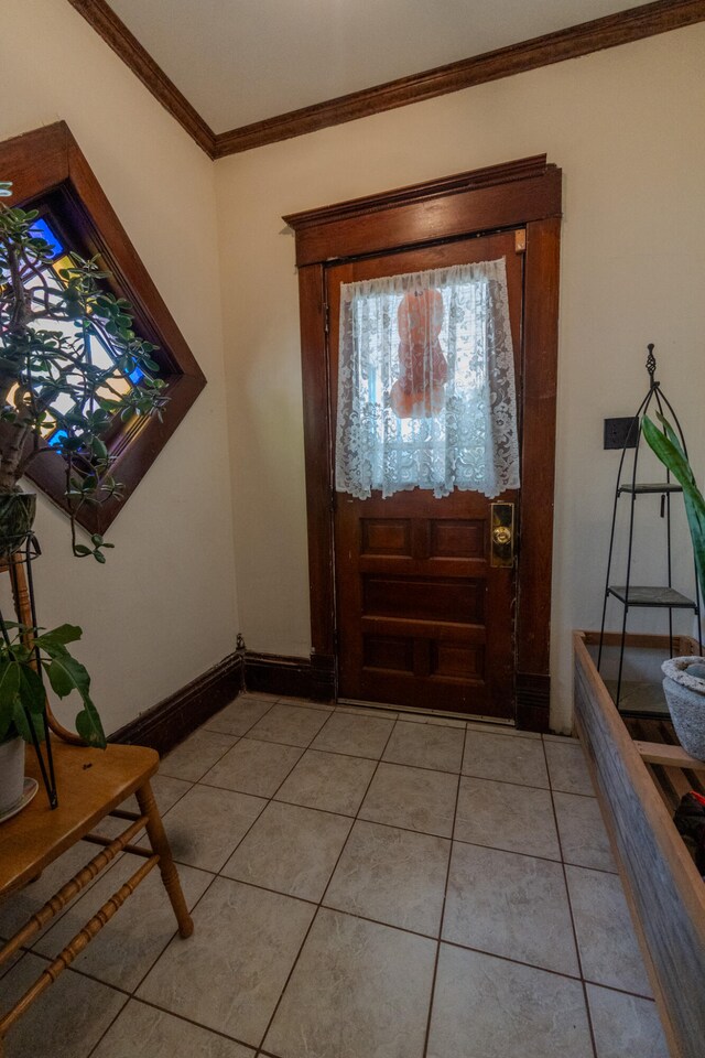 foyer featuring crown molding and light tile patterned floors