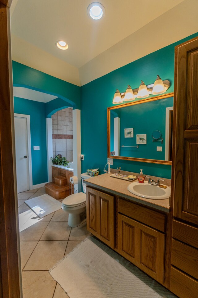 bathroom with vanity, toilet, and tile patterned floors