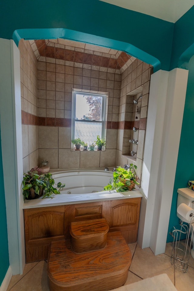 bathroom with a bathtub and tile patterned floors