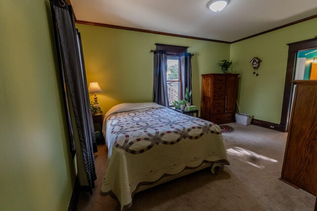 bedroom with ornamental molding and carpet