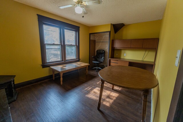 sitting room featuring ceiling fan, a textured ceiling, and dark wood-type flooring