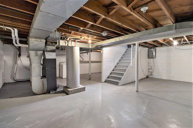 basement featuring electric panel and heating unit