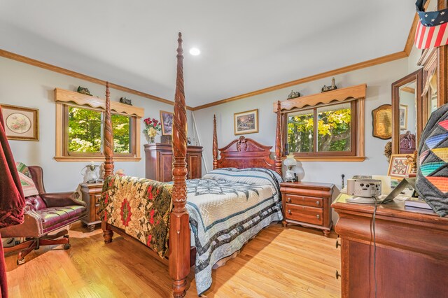 bedroom featuring crown molding and light hardwood / wood-style flooring