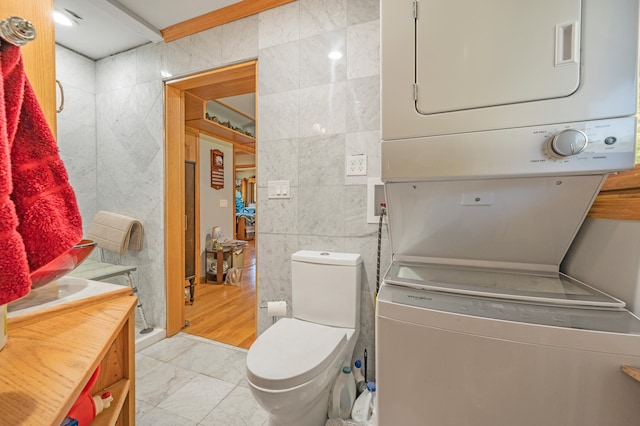 bathroom featuring tile walls and toilet