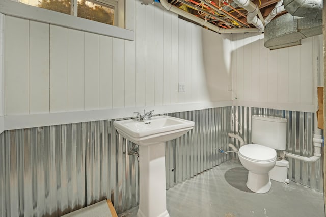 bathroom with toilet and concrete floors