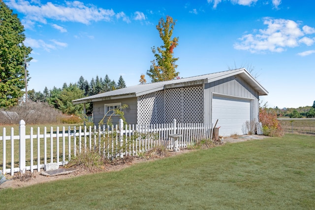 view of front of home with an outbuilding, a front lawn, and a garage