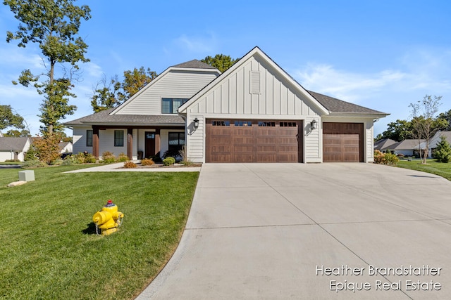 modern inspired farmhouse with a garage and a front lawn