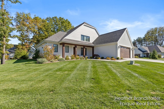 view of front of property with a front yard and a garage