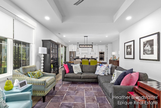 living room with a wealth of natural light and a tray ceiling