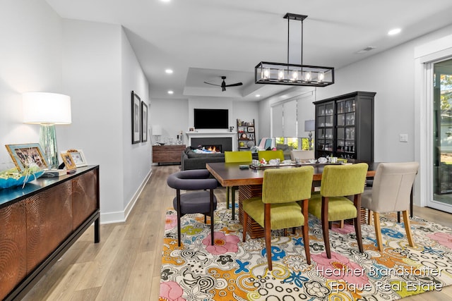 dining space with light wood-type flooring and ceiling fan