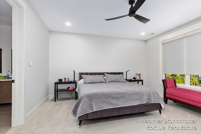 bedroom featuring light colored carpet and ceiling fan