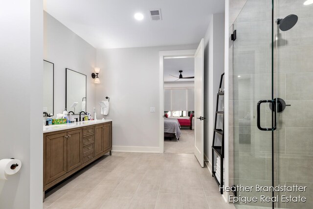 bathroom featuring ceiling fan, vanity, and a shower with shower door