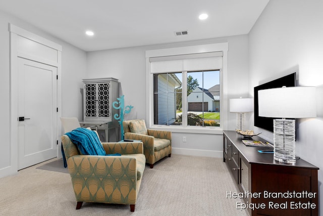 sitting room featuring light colored carpet