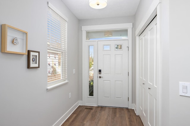 entryway with dark hardwood / wood-style flooring