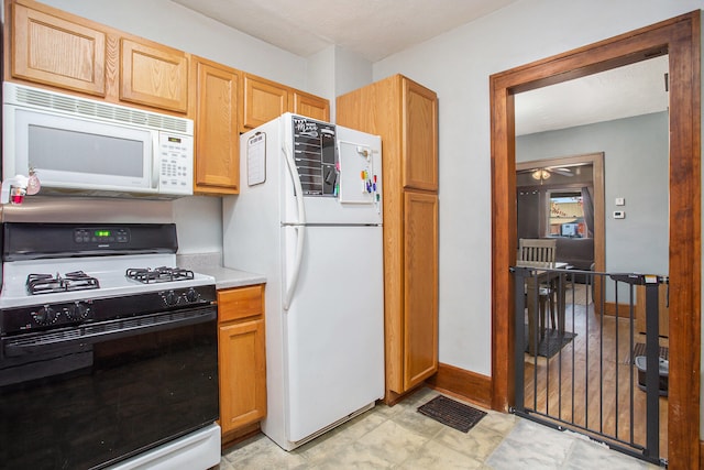 kitchen featuring white appliances and ceiling fan