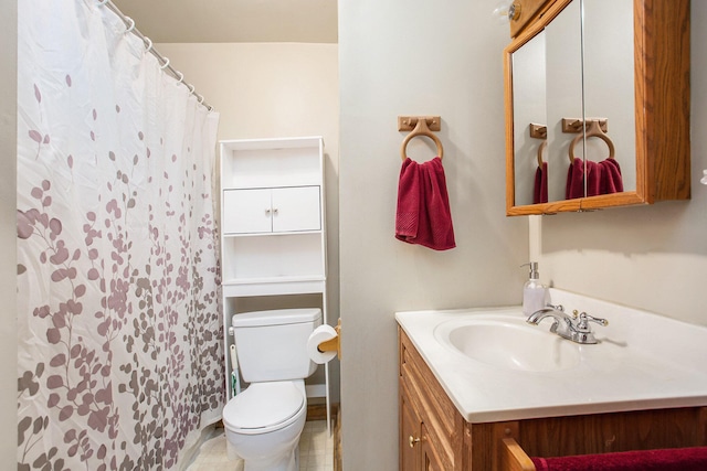 bathroom with vanity, tile patterned flooring, toilet, and walk in shower