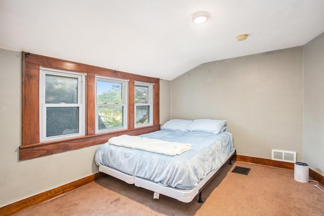 carpeted bedroom with vaulted ceiling