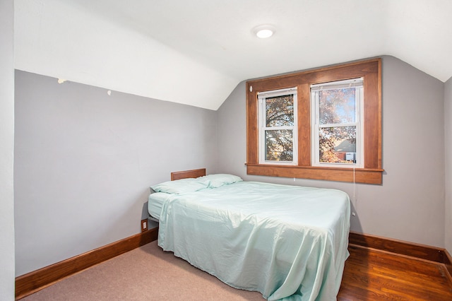 bedroom with hardwood / wood-style floors and vaulted ceiling