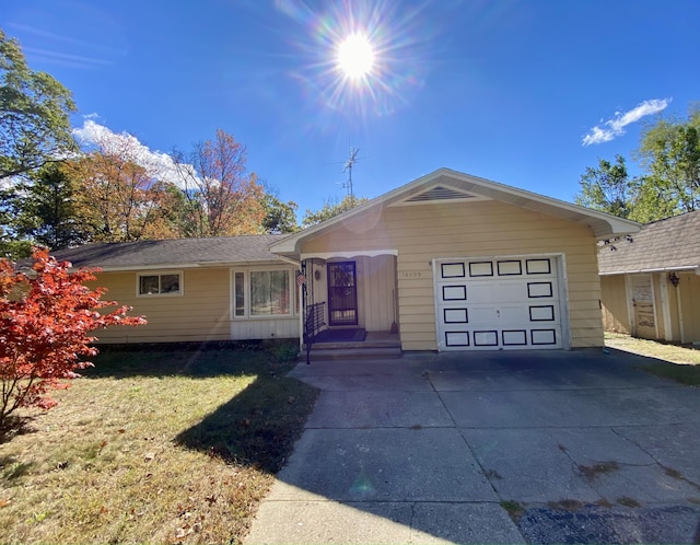 single story home featuring a front yard and a garage