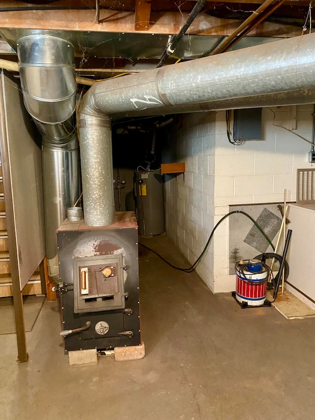 utility room with gas water heater