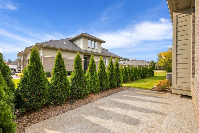 view of side of home featuring a lawn