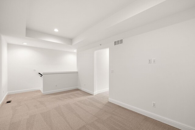 spare room featuring light colored carpet