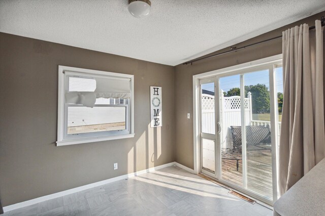 empty room featuring a textured ceiling