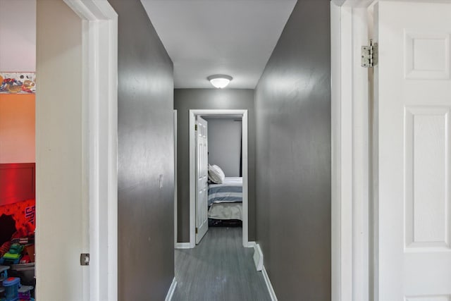 hallway with dark hardwood / wood-style flooring