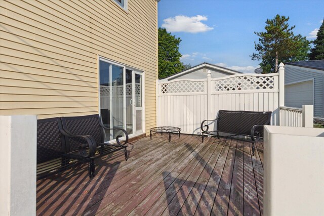 wooden terrace featuring a garage