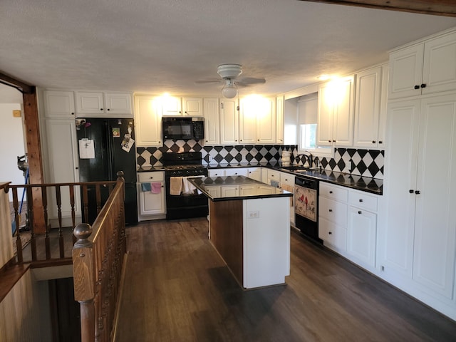 kitchen with white cabinets, a center island, dark wood-type flooring, and black appliances