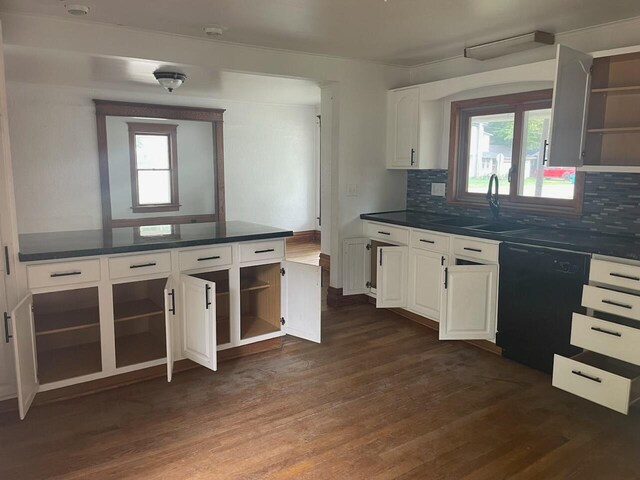 kitchen with decorative backsplash, dark wood-type flooring, sink, dishwasher, and white cabinets