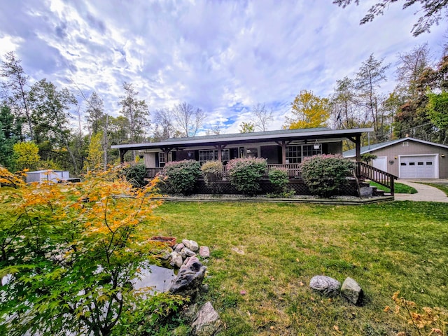 ranch-style home with an outbuilding, covered porch, a front yard, and a garage