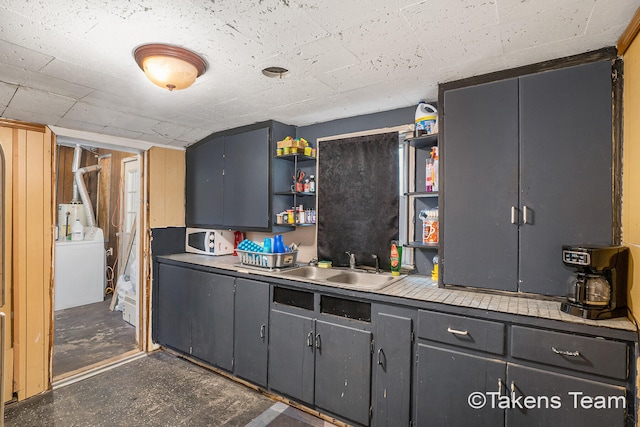 kitchen featuring sink and washer / clothes dryer