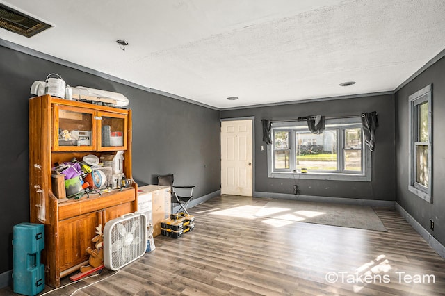 interior space featuring a textured ceiling and hardwood / wood-style flooring