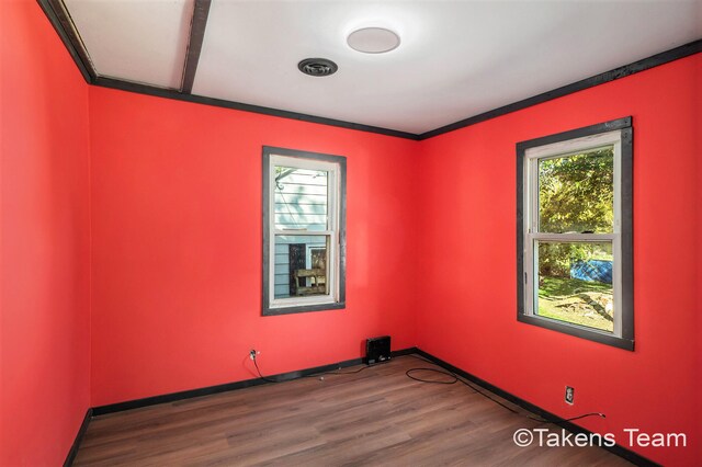 spare room featuring dark hardwood / wood-style flooring