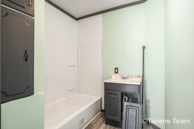 bathroom featuring vanity, bathtub / shower combination, and hardwood / wood-style floors