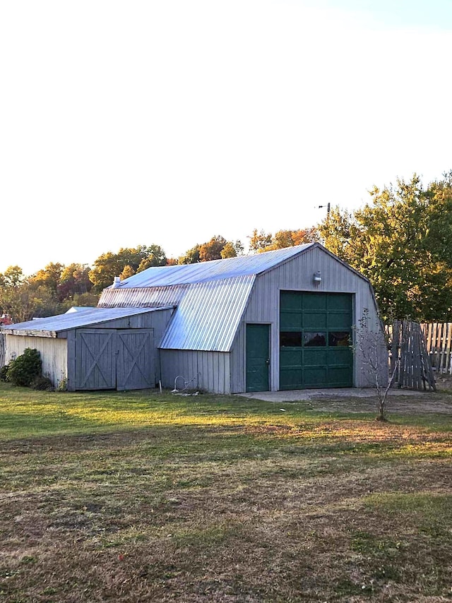 view of outdoor structure with a yard and a garage