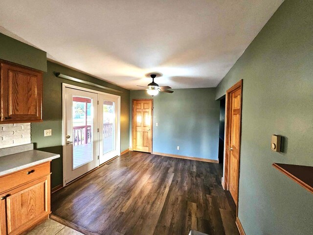 interior space with ceiling fan and dark hardwood / wood-style flooring