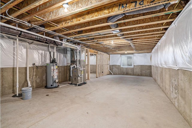 basement featuring heating unit and water heater