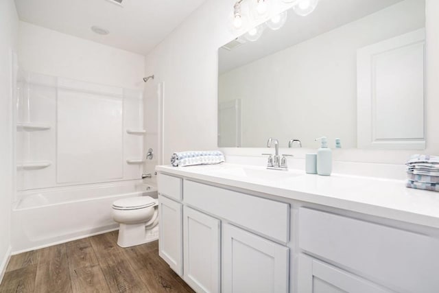 full bathroom featuring hardwood / wood-style floors, vanity, shower / bathtub combination, and toilet