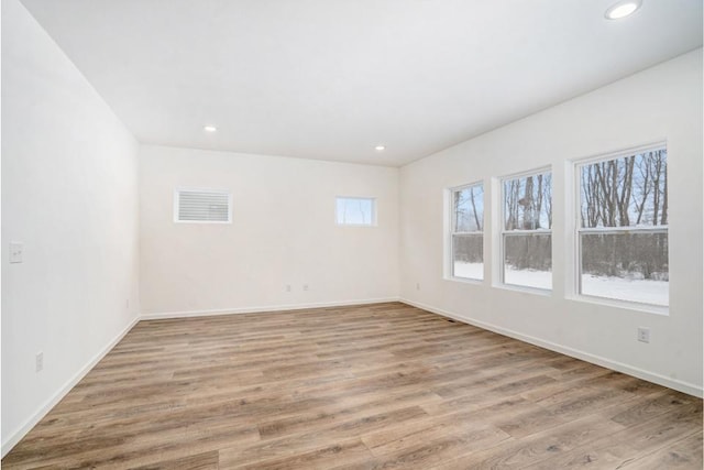 unfurnished room with light hardwood / wood-style flooring