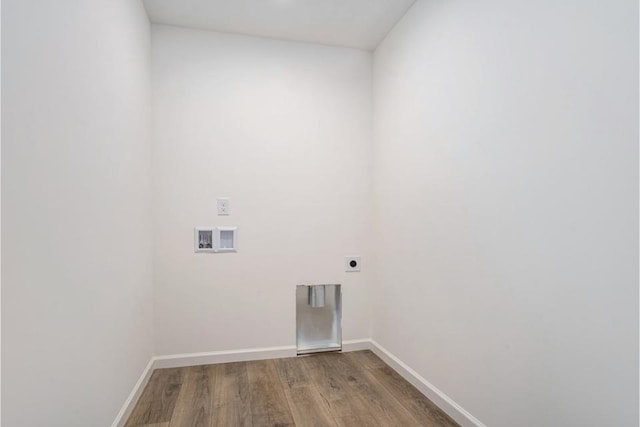 clothes washing area featuring hardwood / wood-style flooring, washer hookup, and hookup for an electric dryer