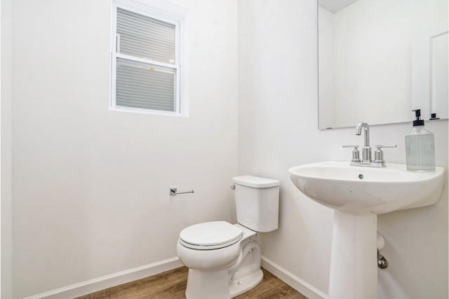 bathroom featuring hardwood / wood-style floors and toilet