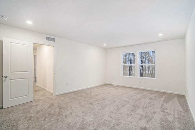 unfurnished room with light carpet