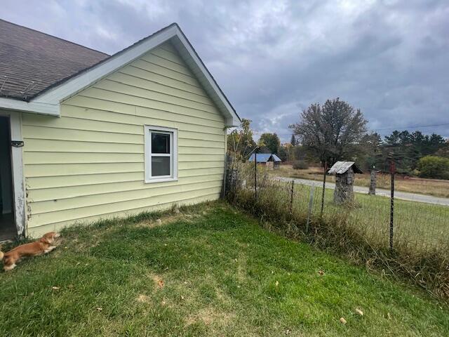 view of side of property with a lawn